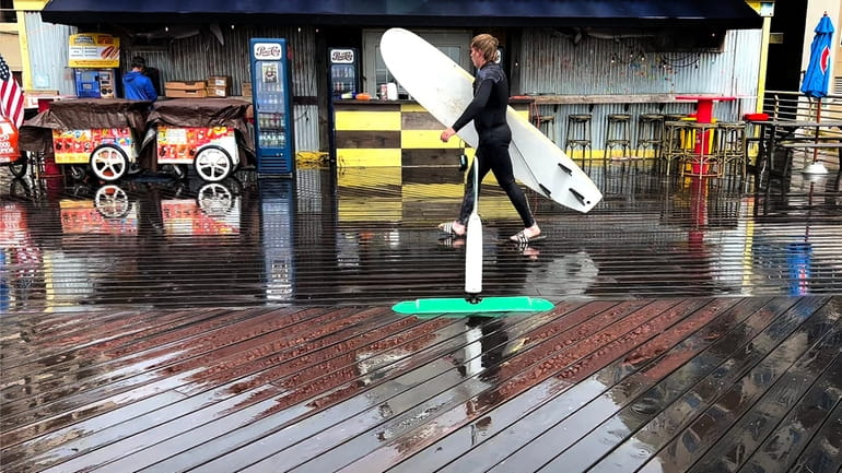 A surfer in Long Beach on Oct. 1. While the...