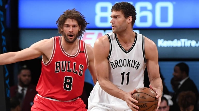 Brooklyn Nets center Brook Lopez is defended by Chicago Bulls...