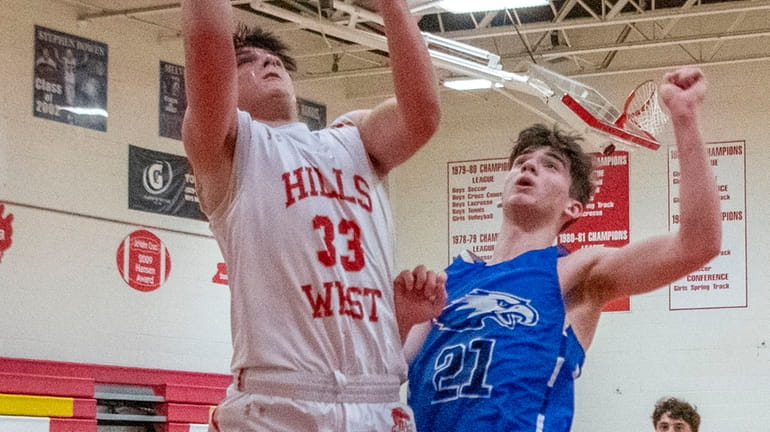 Half Hollow Hills West sophomore Vince Corso shoots a basket...