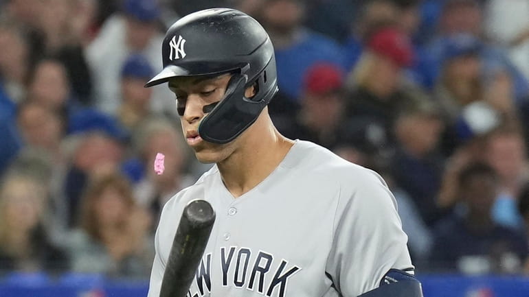 The Yankees' Aaron Judge spits out his gum after striking...