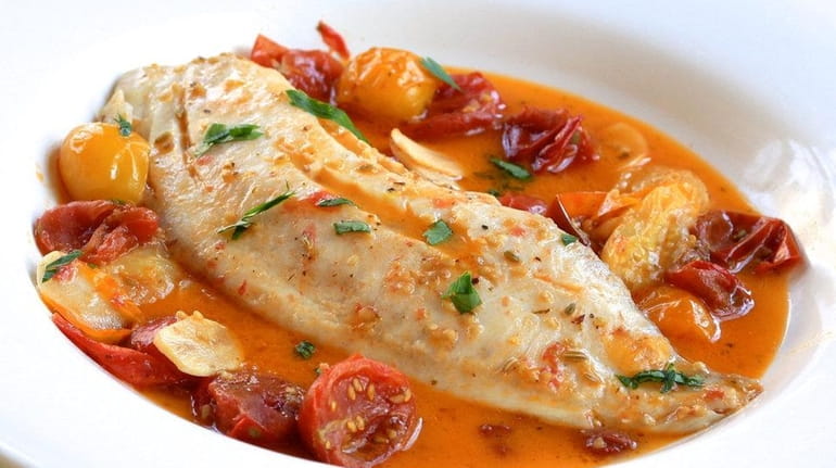 Tilapia is gently simmered in seasoned tomato broth.