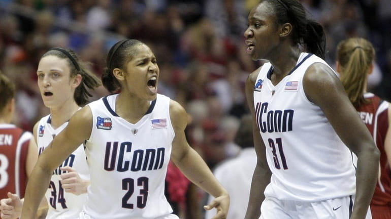 Connecticut's Maya Moore (23) and Tina Charles (31) react in...