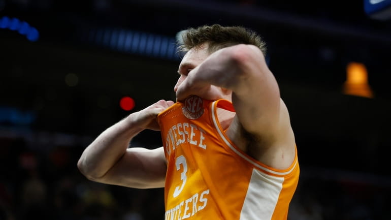 Tennessee guard Dalton Knecht walks off the court atfter the...