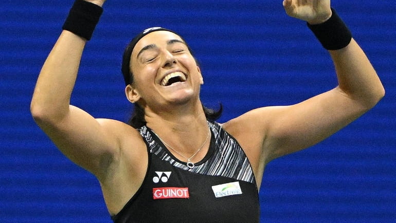 Caroline Garcia reacts after she won her match against Coco...