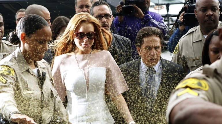 Lindsay Lohan is showered with glitter on March 18, 2013,...