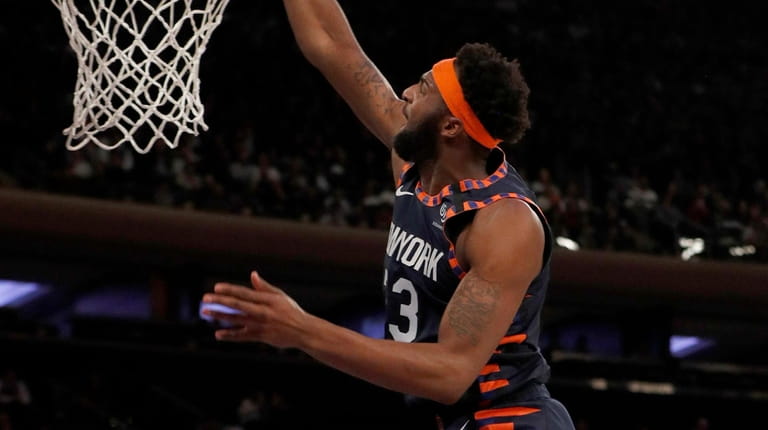 Mitchell Robinson of the Knicks dunks the ball in the...
