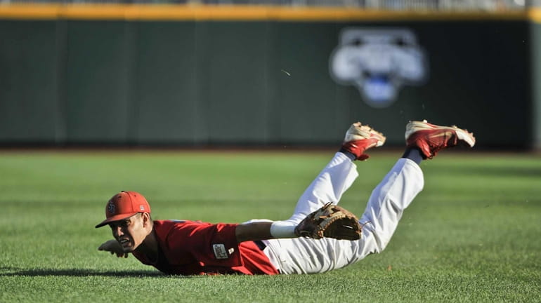 Stony Brook shortstop Cole Peragine remains on the grass after...