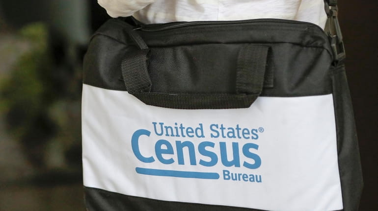 A briefcase of a census taker is seen as she...