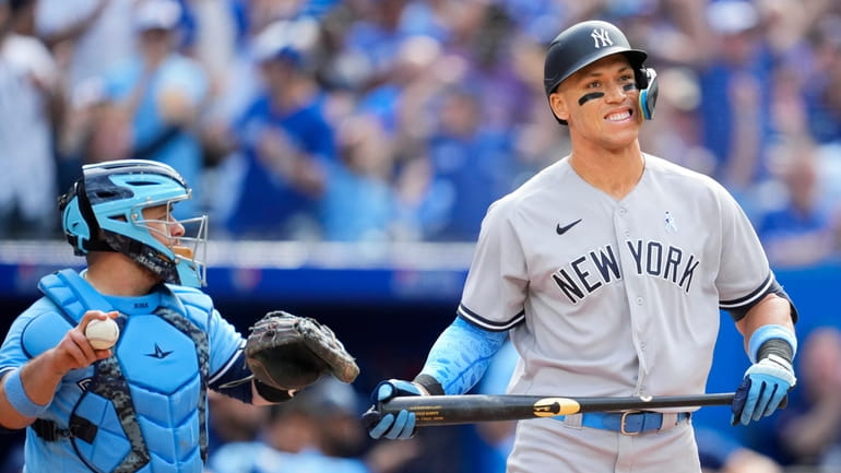 Aaron Judge of the Yankees reacts to striking out against the Blue...