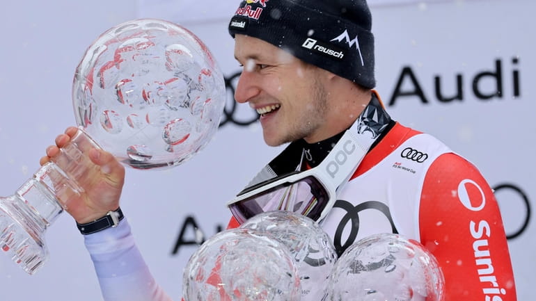 Switzerland's Marco Odermatt holds the alpine ski World Cup overall...