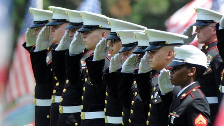 Marines give a final salute to Marine Gunnery Sgt. Thomas...