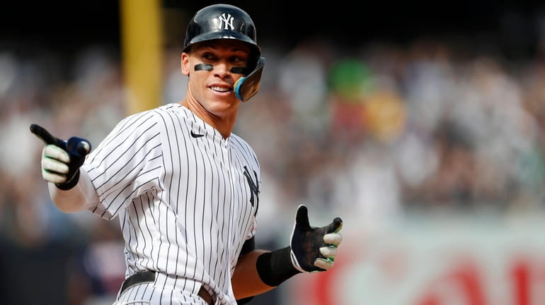 Yankees rightfielder Aaron Judge reacts while rounding the bases after hitting...