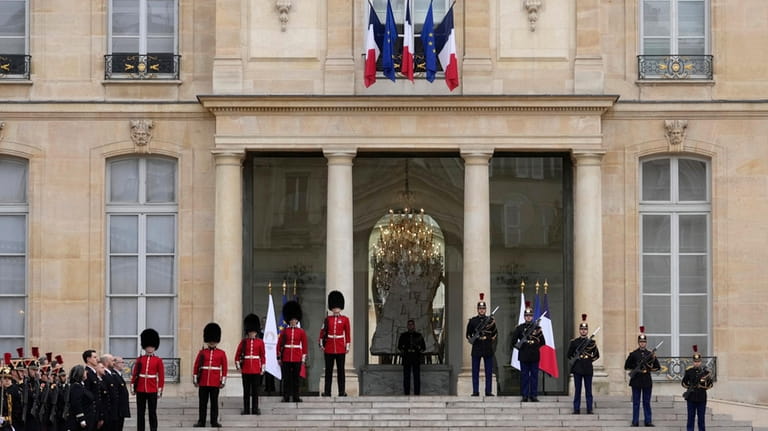 British soldiers and Republican Guards stand guard at the Elysee...
