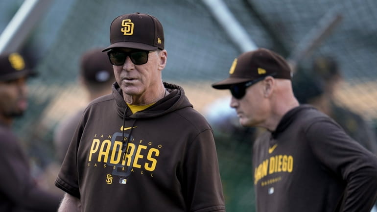 San Diego Padres manager Bob Melvin, left, watches batting practice...