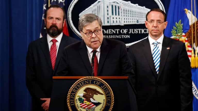 Attorney General William Barr, center, alongside Deputy Attorney General Ed...