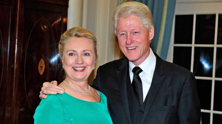 Hillary Clinton and former U.S. President Bill Clinton look on...