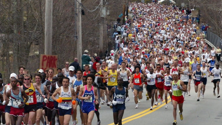 The 110th Boston Marathon elite runners lead the race, Monday,...