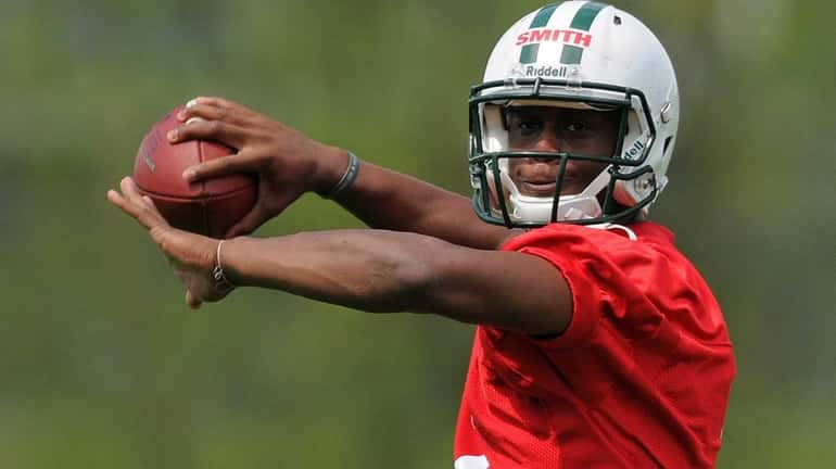 Jets quarterback Geno Smith throws a pass during the team's...