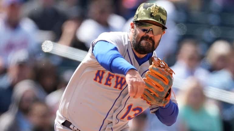 Mets third baseman Luis Guillorme throws to first base to...