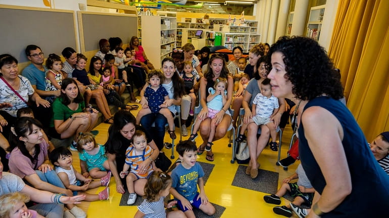 Children's librarian Lesley Siegel entertains kids during Sing and Swing...