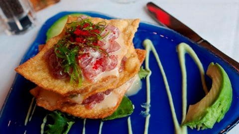 Tuna Napoleon is served with seaweed salad, crispy wontons, avacado,...
