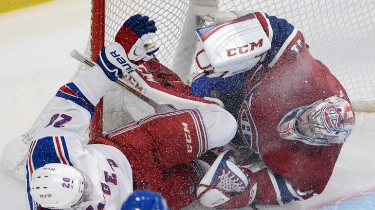 Rangers left wing Chris Kreider (20) crashes into Montreal Canadiens...