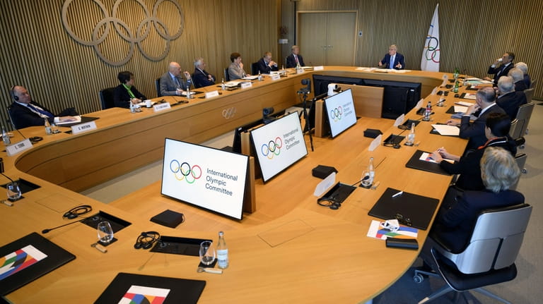 International Olympic Committee (IOC) President Thomas Bach, right up, speaks...