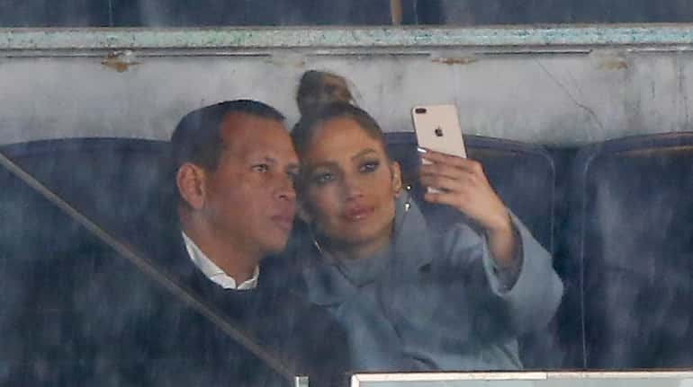 Alex Rodriguez and Jennifer Lopez wait out a fifth inning...
