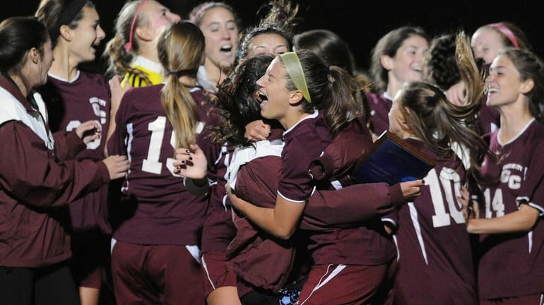 Garden City teammates celebrate after their penalty-kicks win over South...