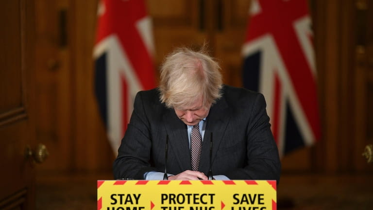 Britain'sPrime Minister Boris Johnson reacts while leading a virtual news...
