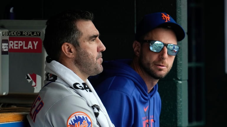Mets pitchers Justin Verlander, left, and Max Scherzer, right, talk...