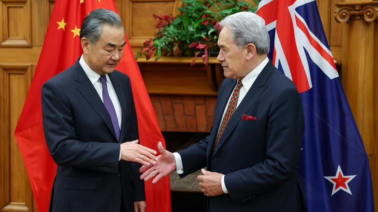 China's Minister of Foreign Affairs Wang Yi, left, meets his...