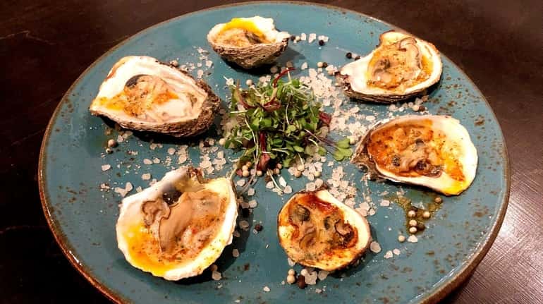 Char-grilled oysters with tomato-absinthe butter is one of the starters...