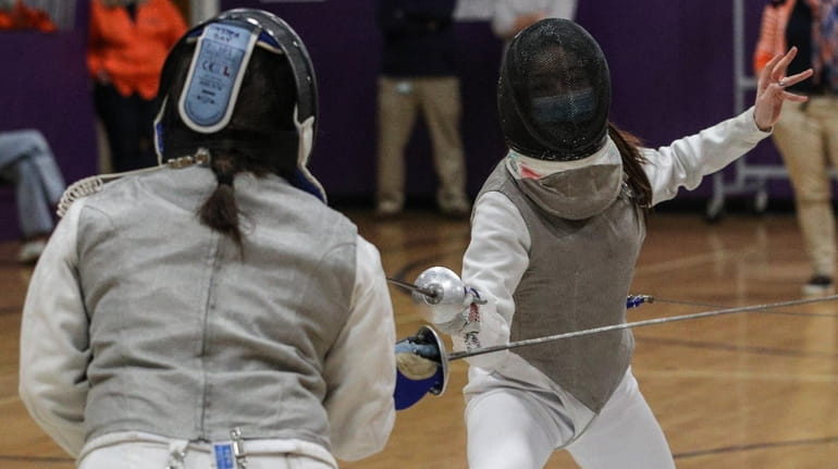 Mandy Li, right, of Great Neck South competes in foil against...