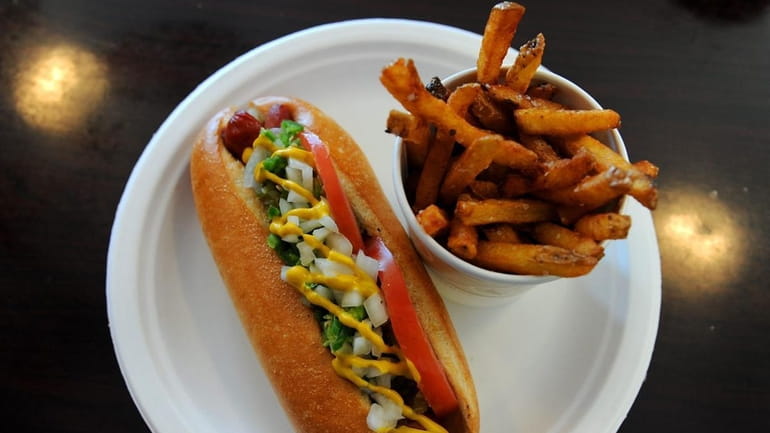 The "Chicago Dog" is covered with onions, relish, tomato, mustard,...