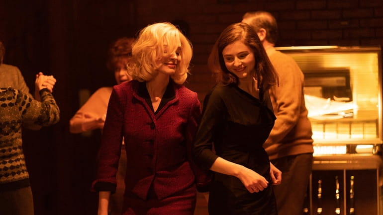 Anne Hathaway, left, and Thomasin McKenzie in a scene from...