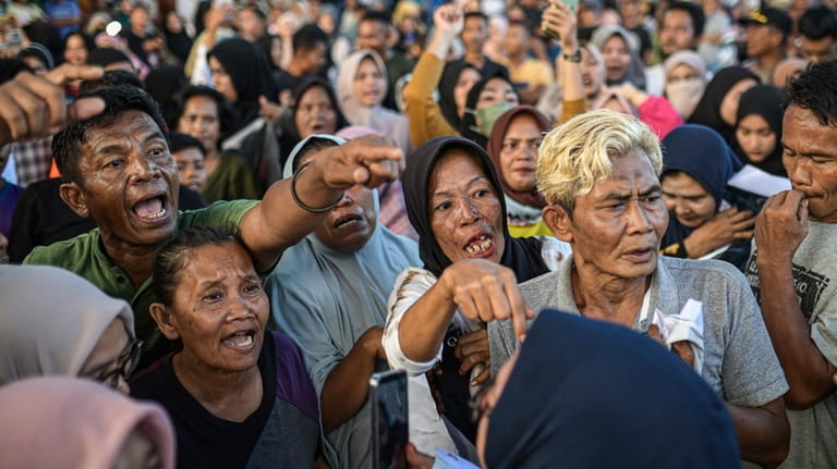 Protesters shout during a rally in Sabang, Aceh province, Indonesia,...