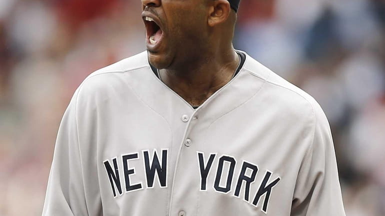Yankees starting pitcher CC Sabathia shouts out while leaving the...