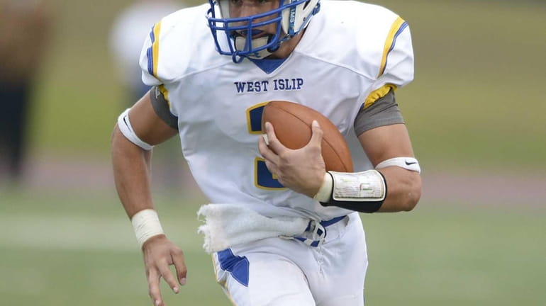 West Islip's Sam Ilario runs for the first down during...