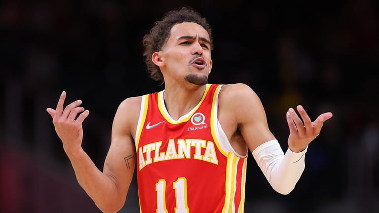 Trae Young of the Atlanta Hawks reacts after drawing a foul...