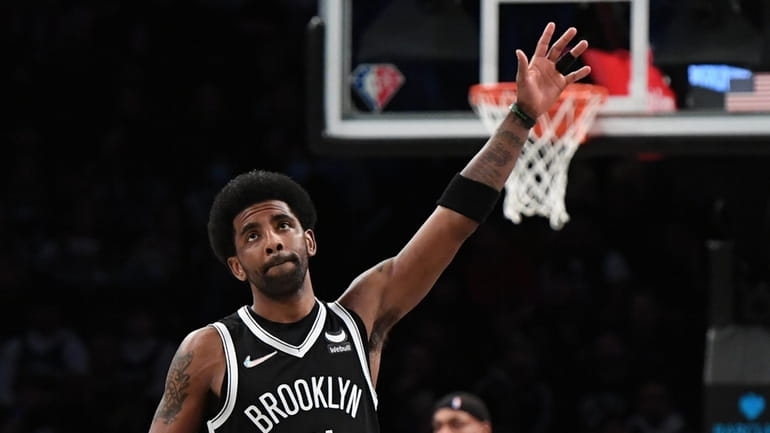 Nets guard Kyrie Irving acknowledges fans before in an NBA...