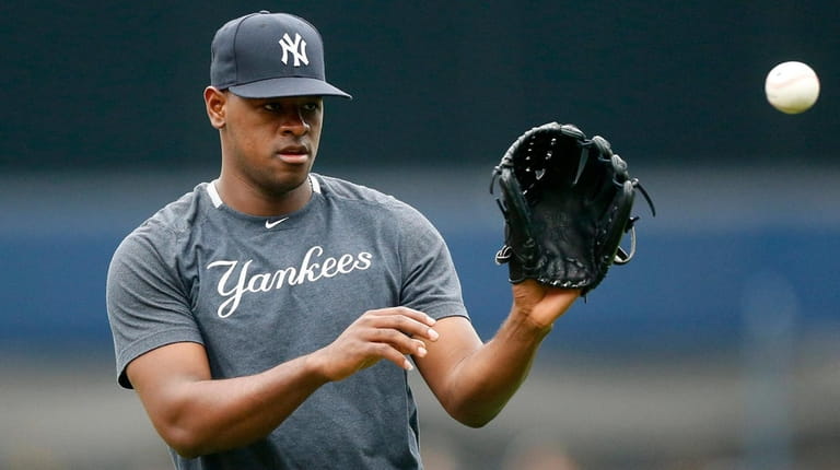 Luis Severino of the Yankees warms up on the field...