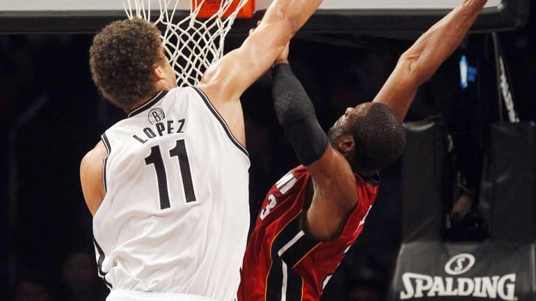 Brook Lopez goes for the block on a shot attempt...