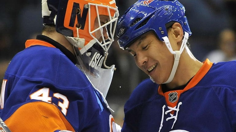 New York Islanders' goalie Martin Biron (43) celebrates the Islanders...