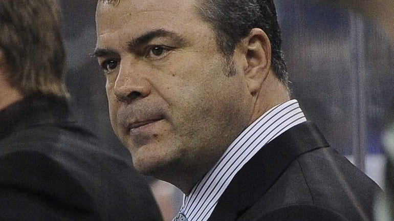 Alain Vigneault looks on during the second period of a...