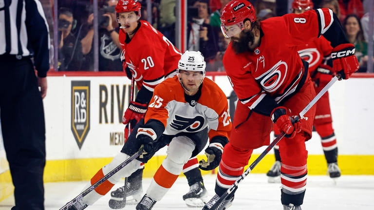Carolina Hurricanes' Brent Burns (8) controls the puck in front...
