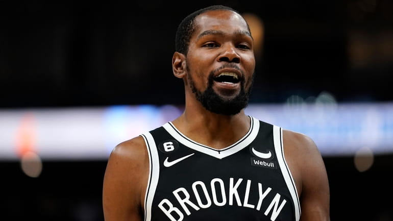 Brooklyn Nets' Kevin Durant laughs during the first half of...