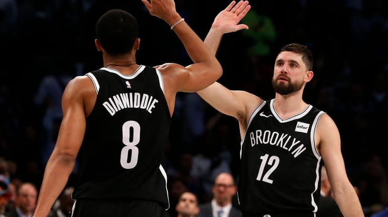 Joe Harris and Spencer Dinwiddie of the Nets celebrate after...
