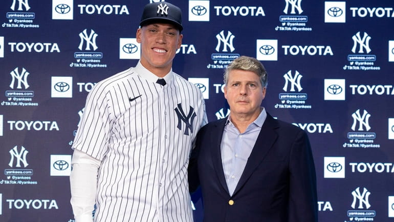 Yankees outfielder Aaron Judge stands with owner Hal Steinbrenner at...