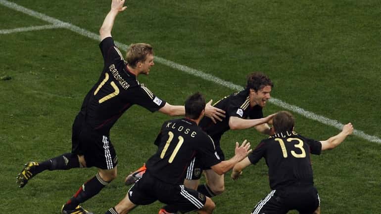 Germany's Arne Friedrich, third from left, celebrates after scoring his...